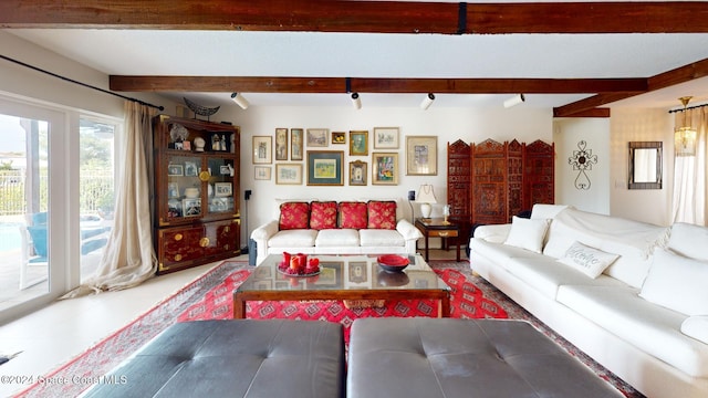 living room with beamed ceiling and rail lighting