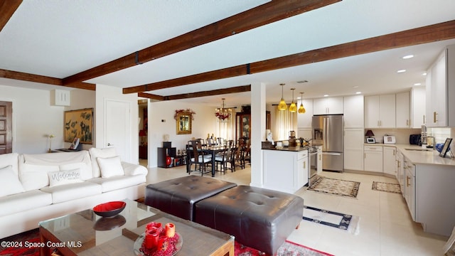 tiled living room with beamed ceiling, sink, and an inviting chandelier