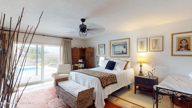 bedroom featuring access to exterior, carpet, a textured ceiling, and ceiling fan