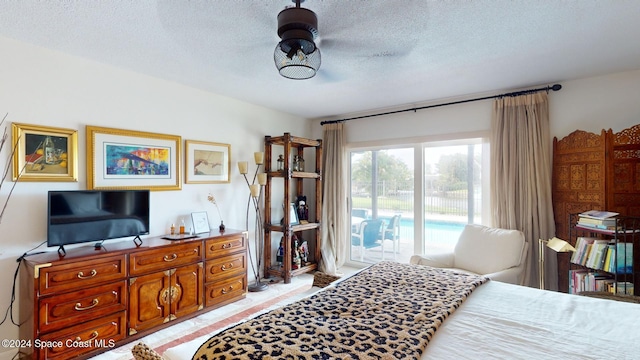 tiled bedroom featuring a textured ceiling and access to outside