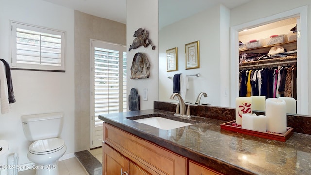 bathroom with vanity, toilet, and tile patterned flooring