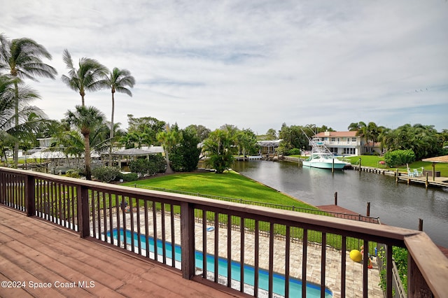 wooden deck featuring a yard and a water view