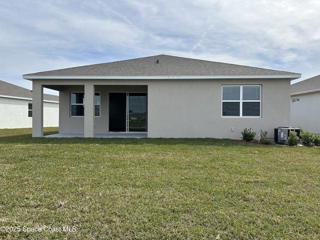 rear view of house with a patio area, a lawn, and central air condition unit