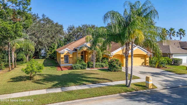 view of front of property with a garage and a front yard