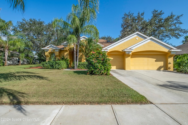 view of front facade featuring a garage and a front lawn