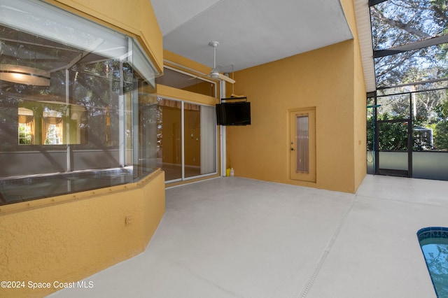 interior space featuring glass enclosure and ceiling fan