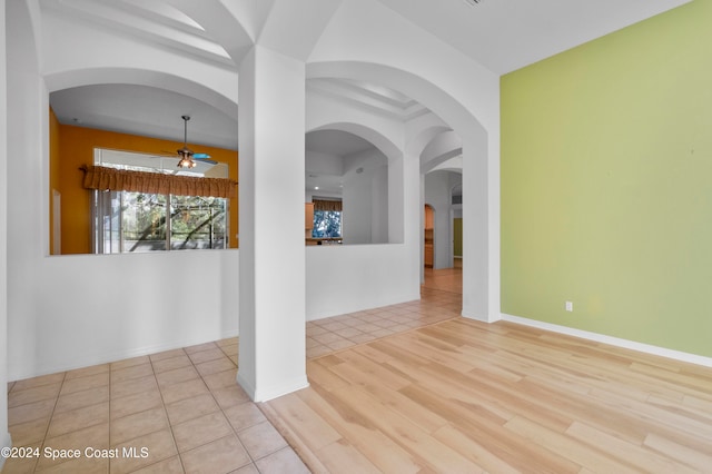 unfurnished room with ceiling fan and light wood-type flooring