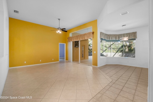 spare room with ceiling fan and light tile patterned floors