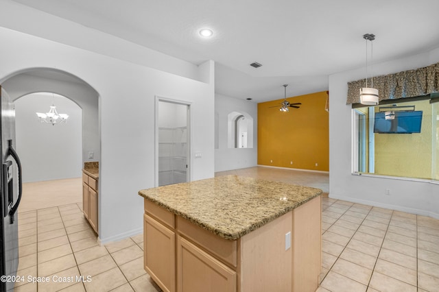 kitchen featuring ceiling fan with notable chandelier, light tile patterned flooring, a center island, and stainless steel refrigerator with ice dispenser