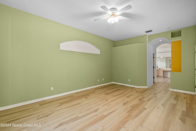 unfurnished room with ceiling fan and light hardwood / wood-style floors