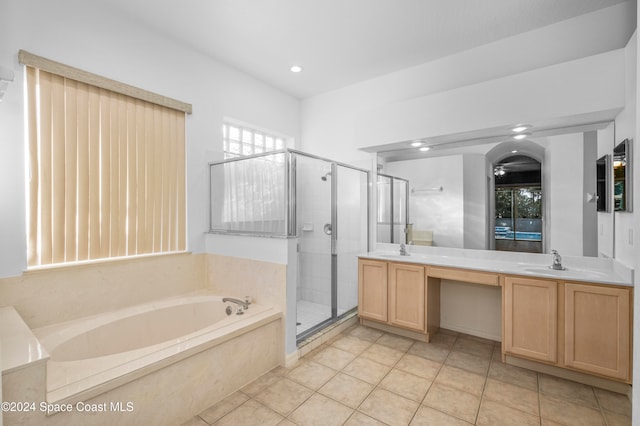 bathroom featuring independent shower and bath, tile patterned flooring, and vanity