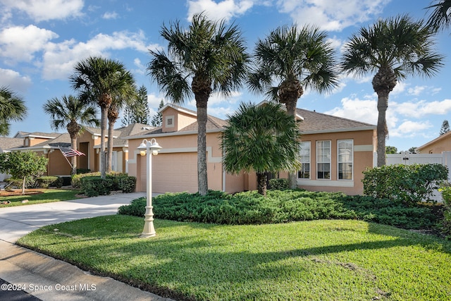 view of front of property with a front yard and a garage