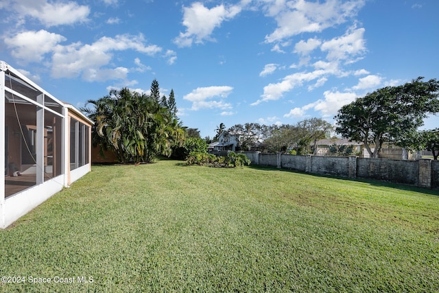 view of yard featuring glass enclosure