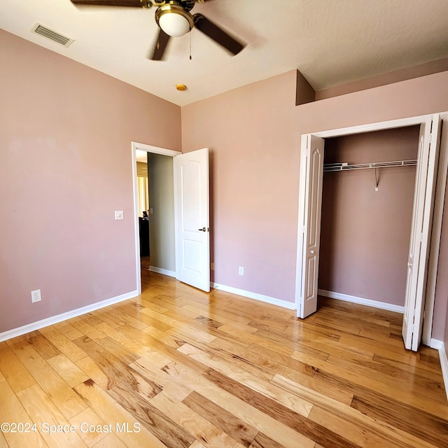 unfurnished bedroom with a closet, ceiling fan, and light hardwood / wood-style flooring