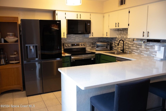 kitchen featuring white cabinetry, sink, light tile patterned flooring, black appliances, and backsplash