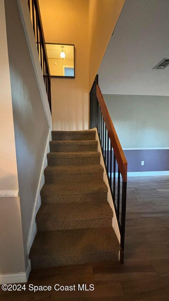 stairway featuring wood-type flooring