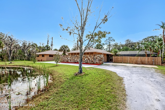 view of front of home with a water view and a front yard