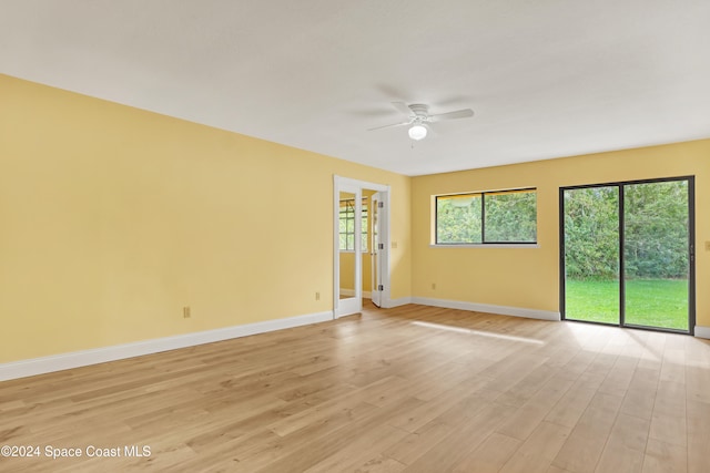 spare room with ceiling fan and light hardwood / wood-style floors