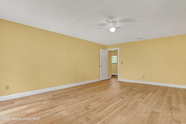 empty room with light wood-type flooring and ceiling fan