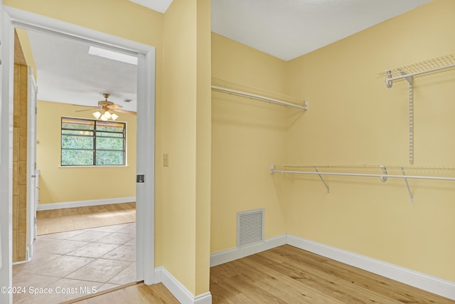 spacious closet with ceiling fan and wood-type flooring