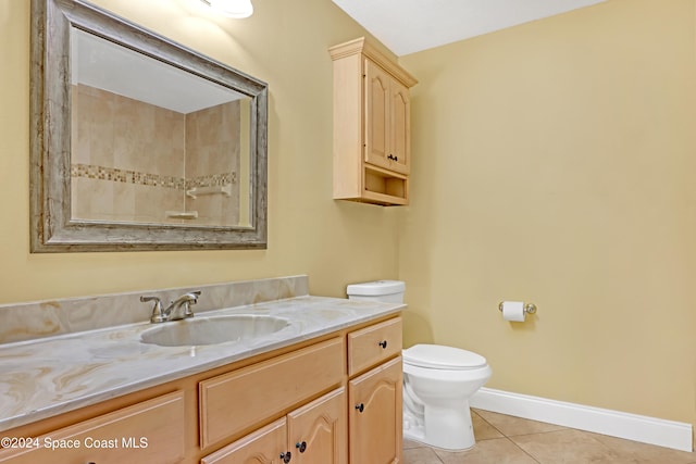 bathroom with tile patterned floors, vanity, and toilet