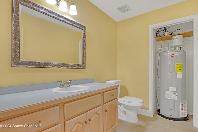 bathroom featuring tile patterned floors, water heater, vanity, and toilet