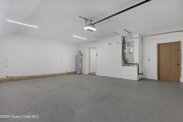 garage featuring heating unit, water heater, and a garage door opener