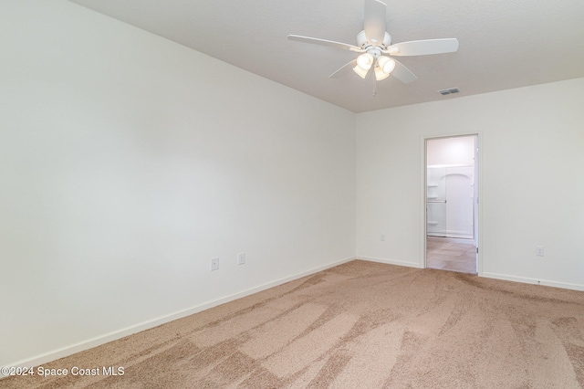 unfurnished room with carpet and ceiling fan