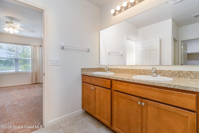 bathroom with tile patterned flooring, vanity, and ceiling fan