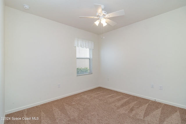 spare room with carpet flooring and ceiling fan