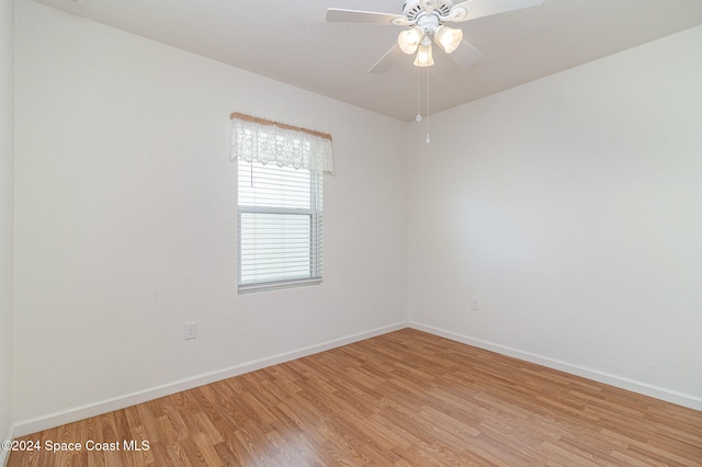 empty room with ceiling fan and light wood-type flooring