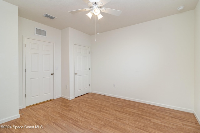 unfurnished bedroom with light hardwood / wood-style floors and ceiling fan