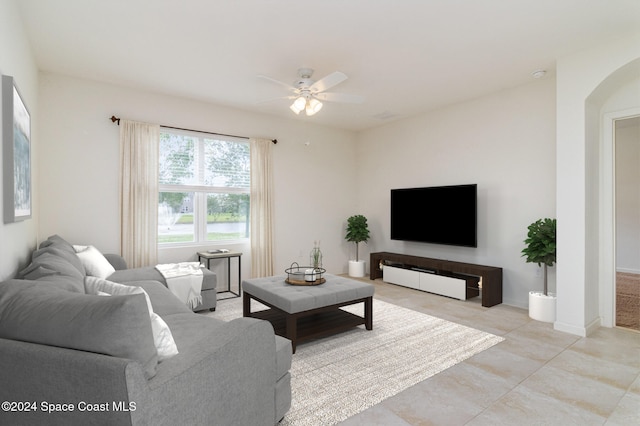 tiled living room with ceiling fan