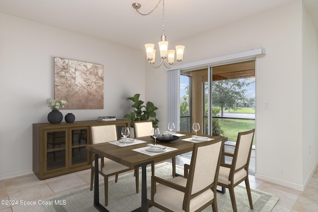 tiled dining space featuring an inviting chandelier