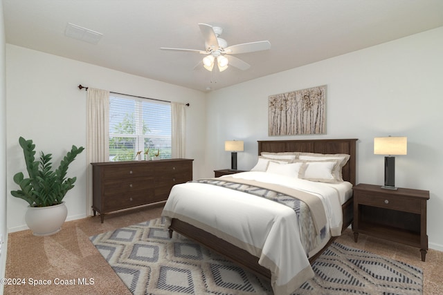 bedroom with ceiling fan and light colored carpet