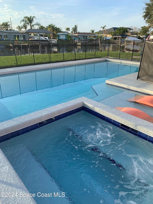 view of swimming pool with a lawn