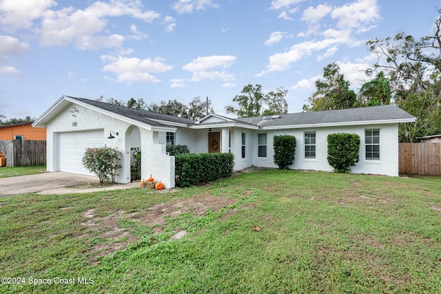 ranch-style house with a garage and a front lawn