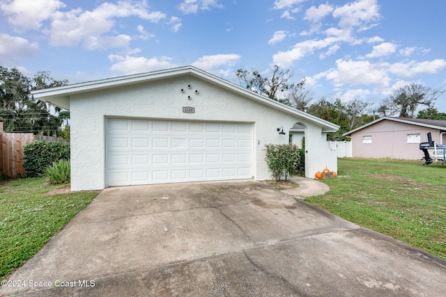 ranch-style house with a garage and a front lawn