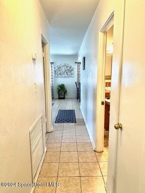 corridor featuring light tile patterned floors