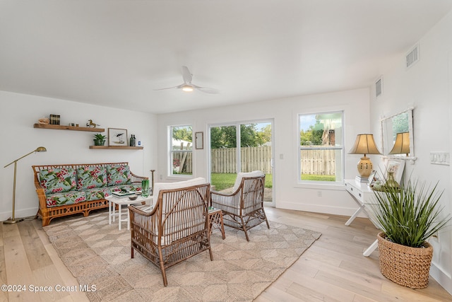 living room featuring ceiling fan and light hardwood / wood-style flooring