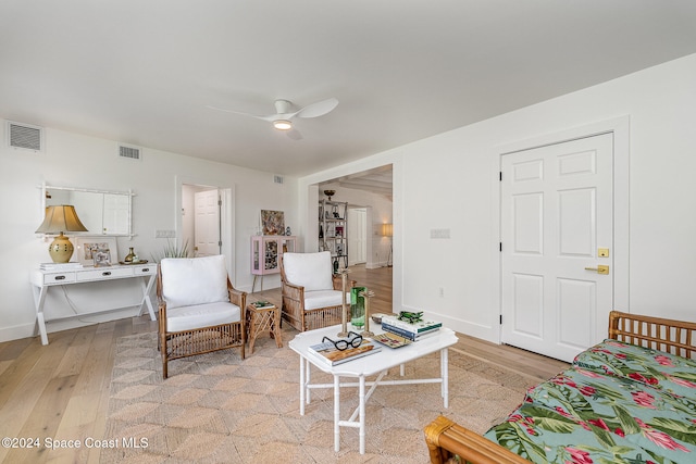 living room with ceiling fan and light hardwood / wood-style floors