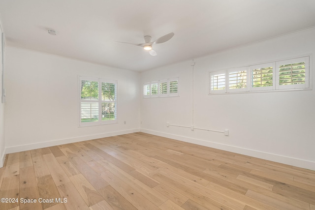 unfurnished room with light wood-type flooring, ceiling fan, and ornamental molding