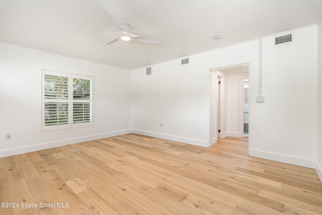 spare room with ceiling fan, light hardwood / wood-style floors, and ornamental molding