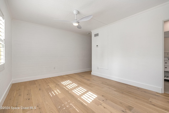 empty room featuring wood-type flooring, ceiling fan, and crown molding