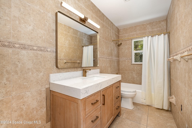 full bathroom featuring tile patterned flooring, vanity, toilet, and tile walls