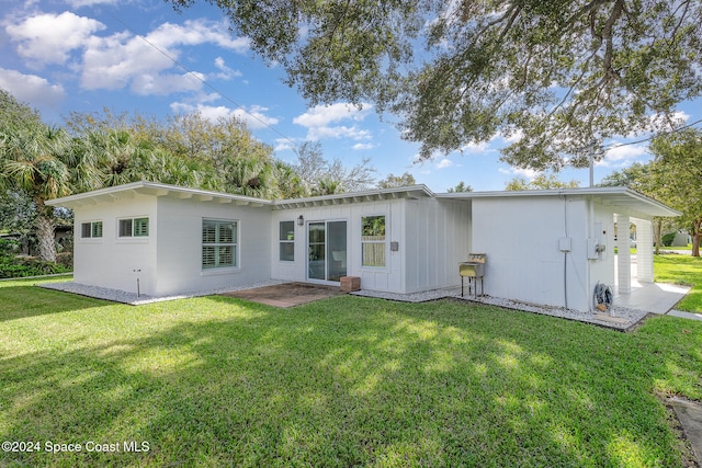 back of property with a lawn