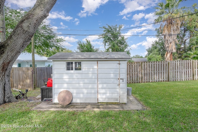 view of outbuilding featuring a lawn