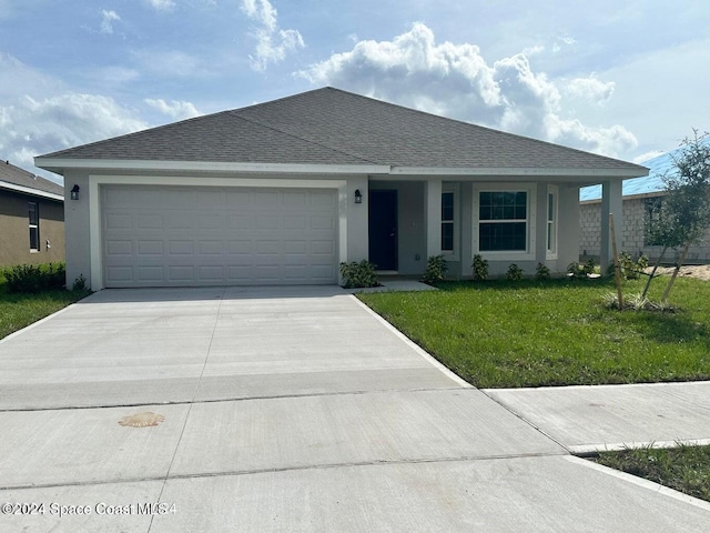 single story home featuring a front lawn and a garage