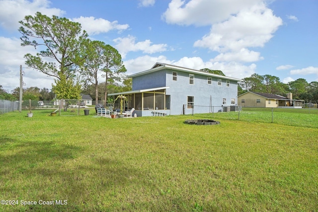 back of house with a sunroom and a yard