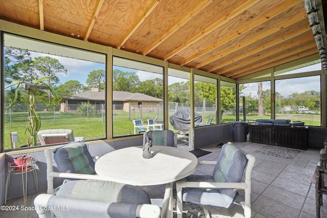 sunroom / solarium featuring lofted ceiling